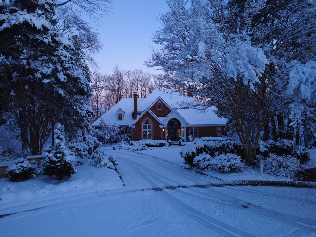 Front aerial view of a home in snow